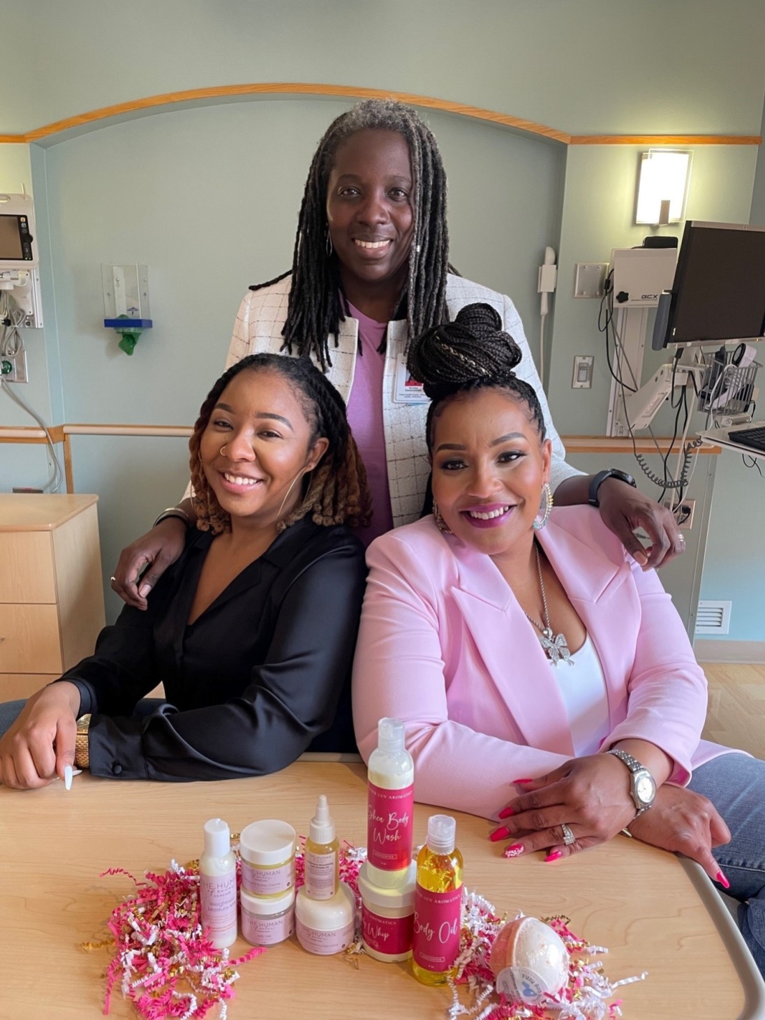 Dr. Nneka Sederstrom (back), with Tianna Thompson and Alicia Thomas.
